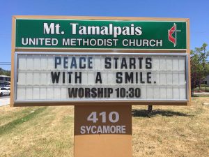 Sign Text: Peace starts with a smile. Worship 10:30am