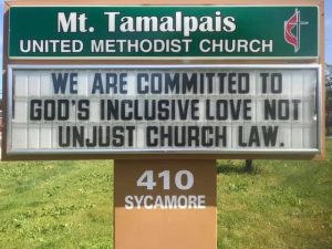 Sign Text: We are committed to God's inclusive love not unjust church law.